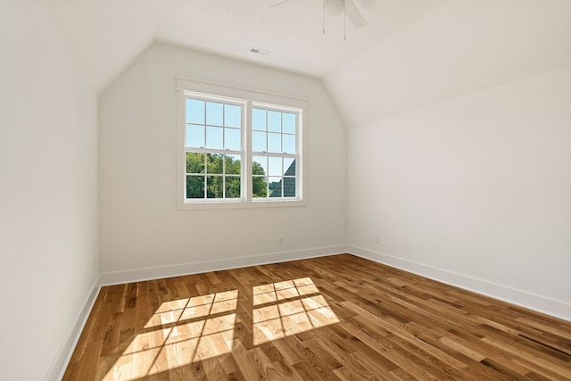 additional living space featuring lofted ceiling, hardwood / wood-style floors, and ceiling fan