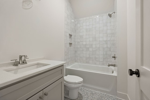 full bathroom with vanity, tiled shower / bath combo, and toilet