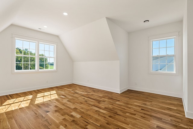 bonus room featuring vaulted ceiling and hardwood / wood-style flooring