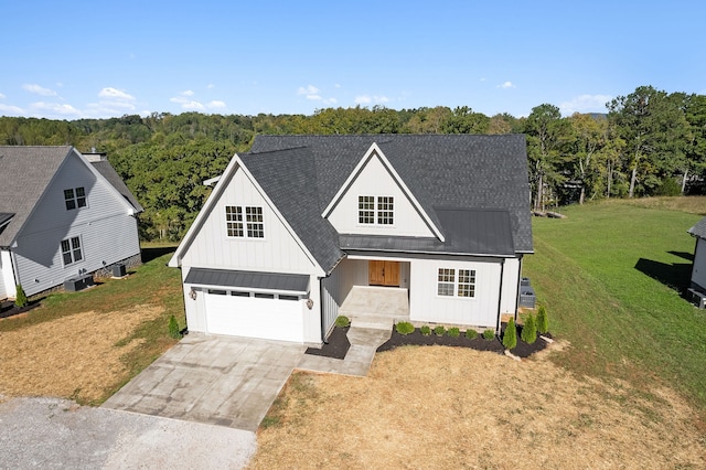 modern farmhouse style home with a garage, cooling unit, and a front lawn