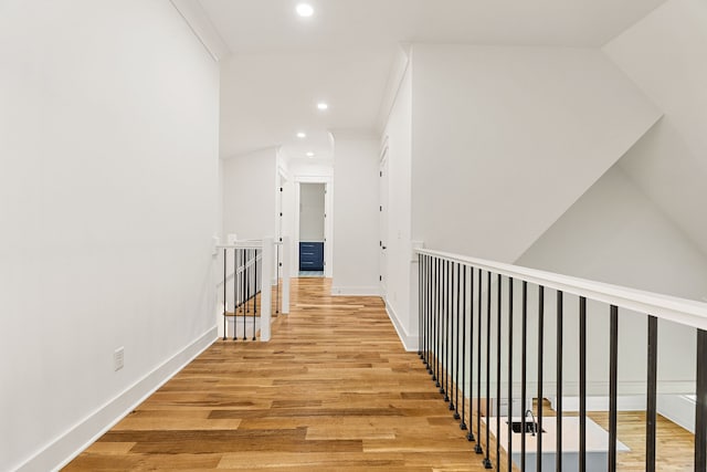 hall with crown molding and light hardwood / wood-style flooring