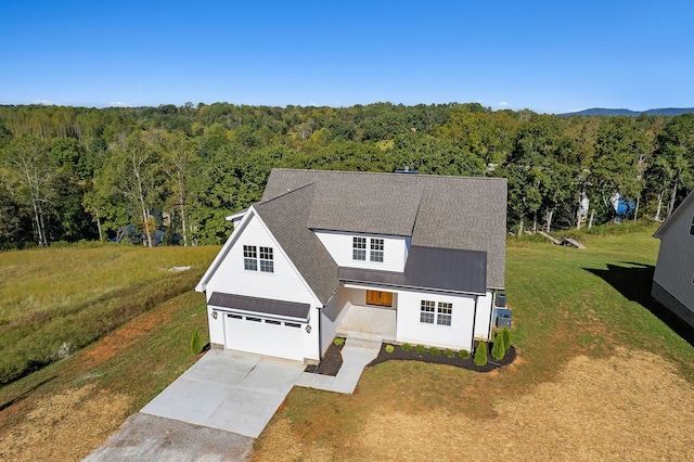 view of front of property featuring a front yard and a garage