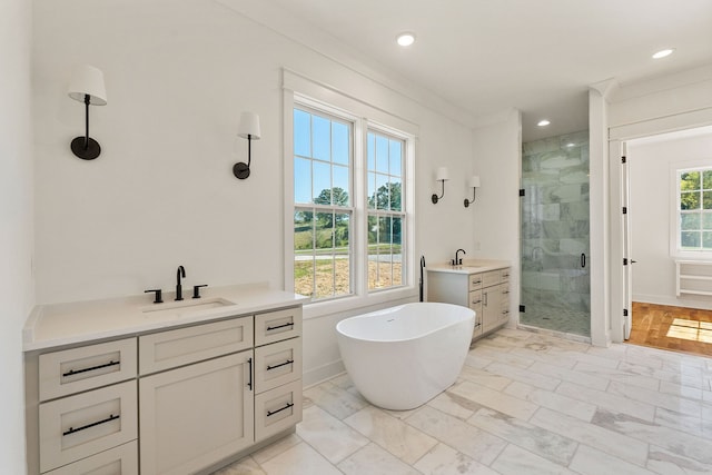 bathroom with crown molding, vanity, and shower with separate bathtub