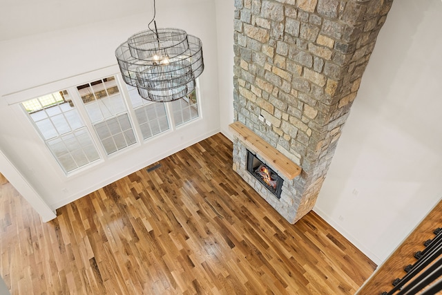 interior space featuring a fireplace, hardwood / wood-style floors, and a chandelier