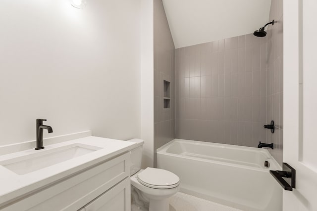 full bathroom with lofted ceiling, vanity, toilet, and tiled shower / bath