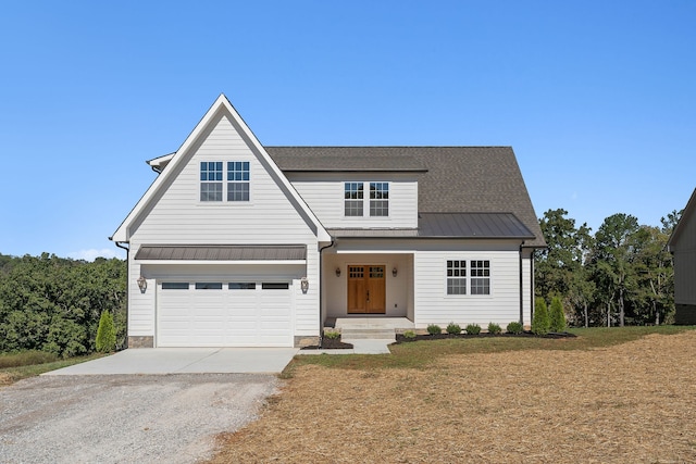 view of front of home with a garage and a front lawn