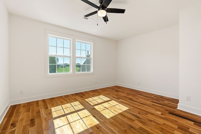 empty room featuring wood-type flooring and ceiling fan