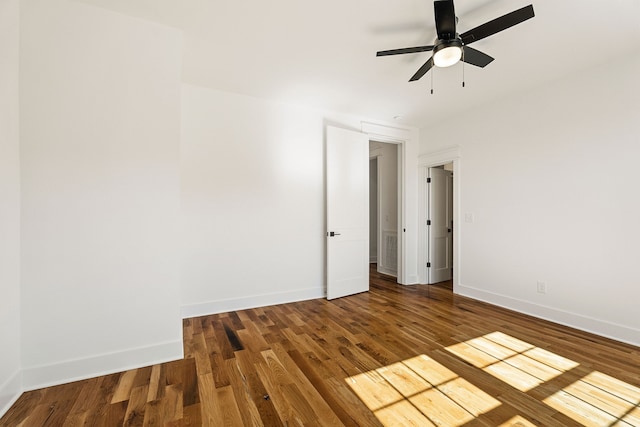 empty room featuring dark hardwood / wood-style floors and ceiling fan