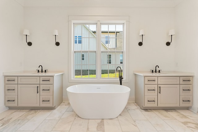 bathroom with vanity and a bath