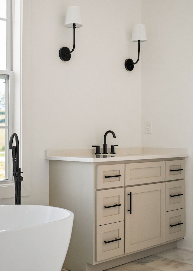 bathroom with a bath and vanity