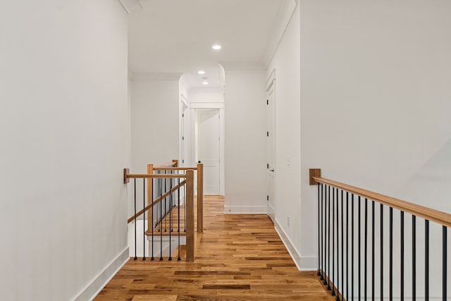 corridor with crown molding and hardwood / wood-style floors