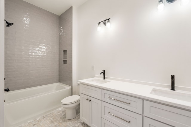 full bathroom with tiled shower / bath, tile patterned floors, vanity, and toilet