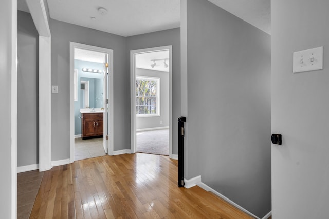 hall with light hardwood / wood-style flooring