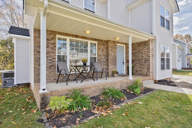 view of patio with cooling unit and covered porch