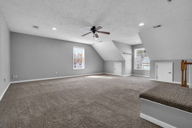 additional living space featuring a textured ceiling and plenty of natural light