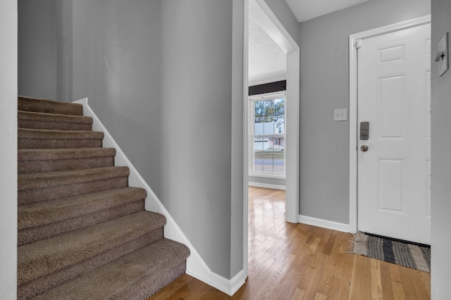 foyer featuring light hardwood / wood-style flooring and a textured ceiling