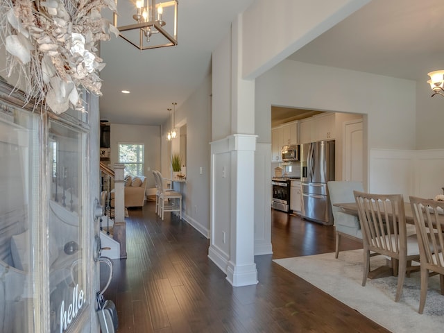 foyer featuring dark wood-type flooring and a chandelier