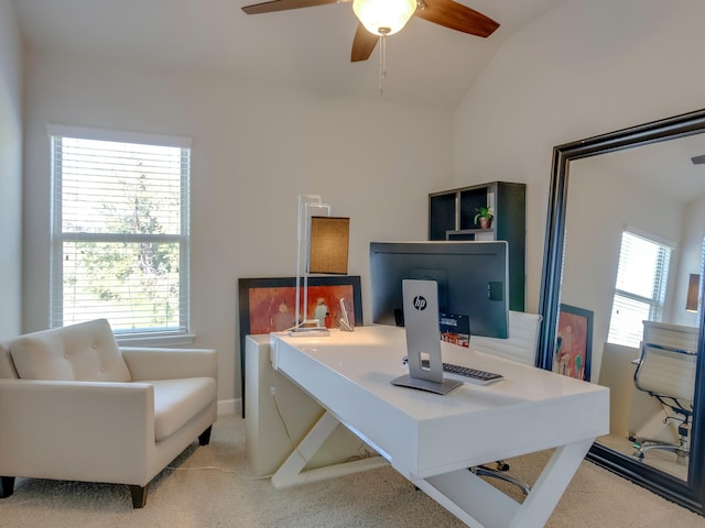 carpeted office with lofted ceiling and ceiling fan