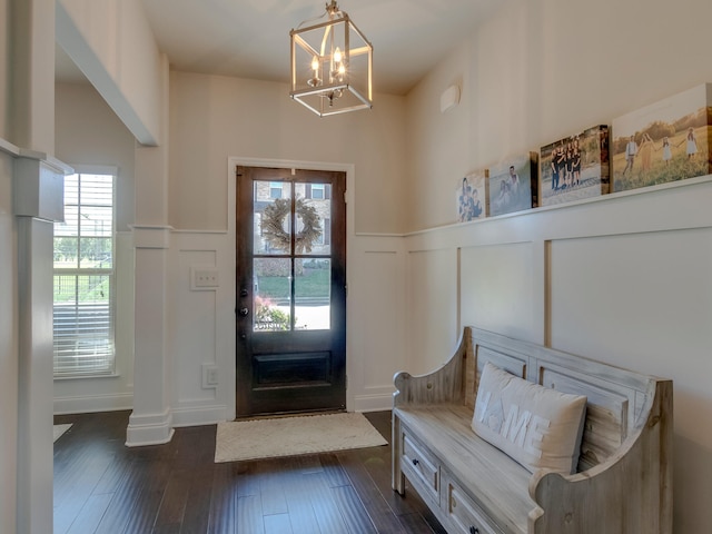 foyer featuring a healthy amount of sunlight, dark wood-type flooring, and a chandelier