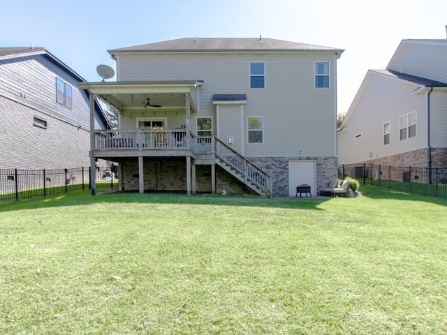 back of house with a yard, a wooden deck, and ceiling fan