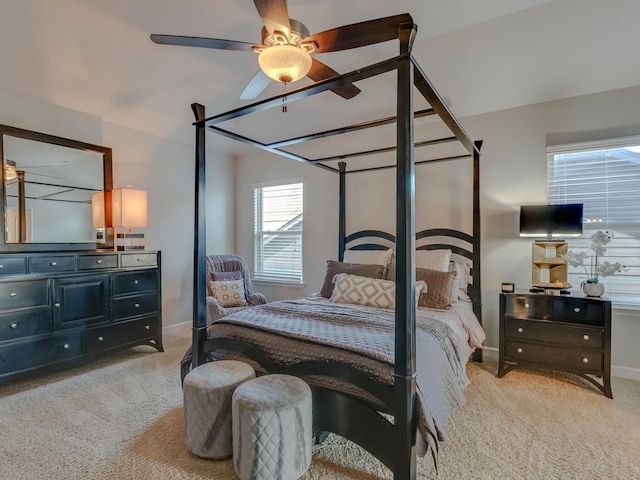 bedroom with light carpet and ceiling fan