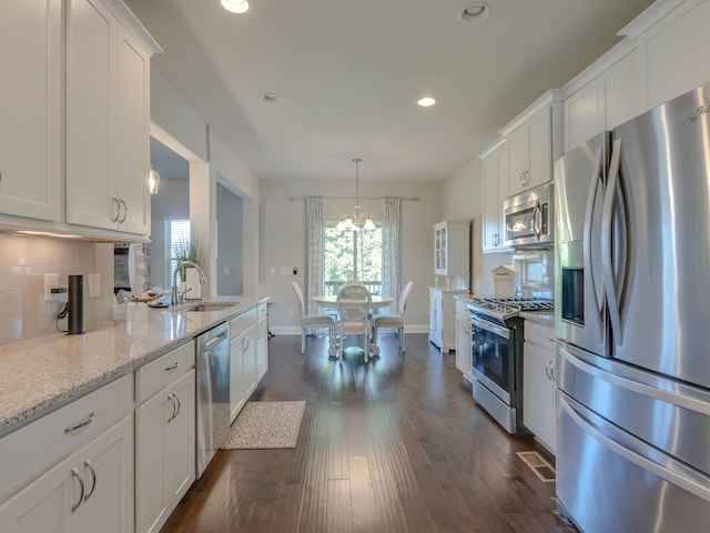 kitchen with white cabinets, appliances with stainless steel finishes, sink, and dark hardwood / wood-style flooring