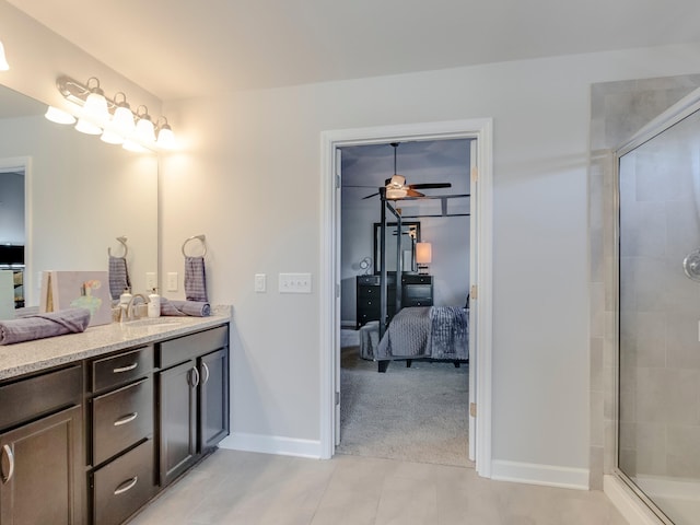 bathroom featuring tile patterned floors, a shower with shower door, vanity, and ceiling fan