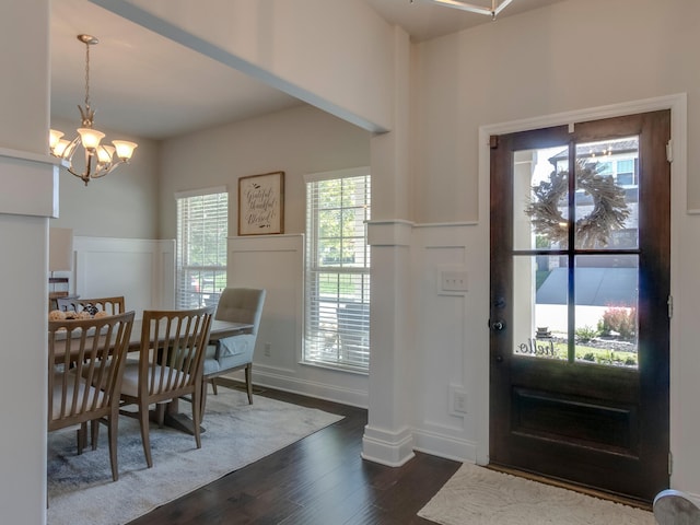 entrance foyer with a notable chandelier and dark hardwood / wood-style floors