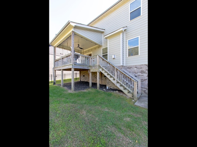 back of house with a yard, ceiling fan, and a deck