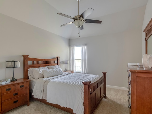 bedroom with ceiling fan, light colored carpet, and vaulted ceiling