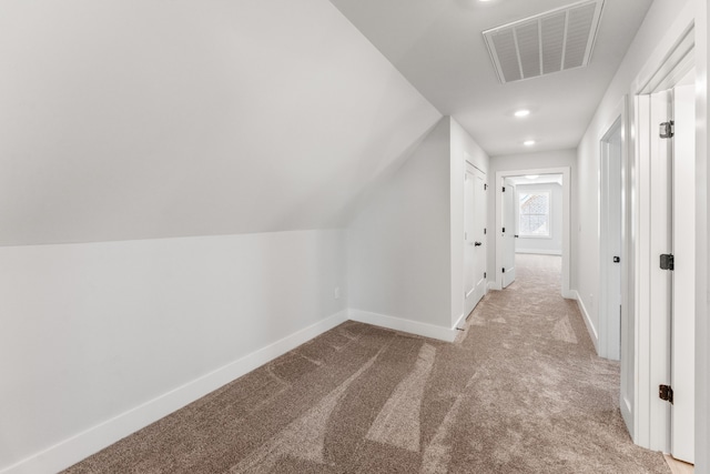 additional living space with light colored carpet and lofted ceiling