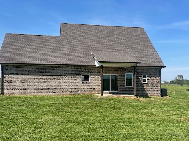 rear view of property with a yard and a patio