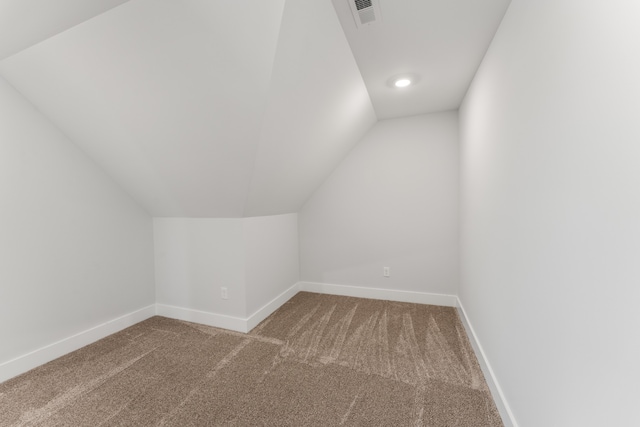 bonus room featuring lofted ceiling and carpet