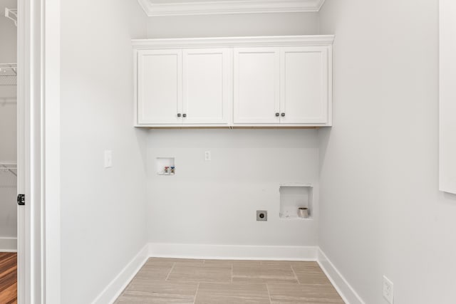 laundry area with hookup for a washing machine, cabinets, crown molding, and electric dryer hookup