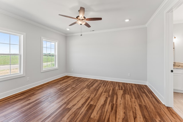 spare room with crown molding, ceiling fan, and dark wood-type flooring