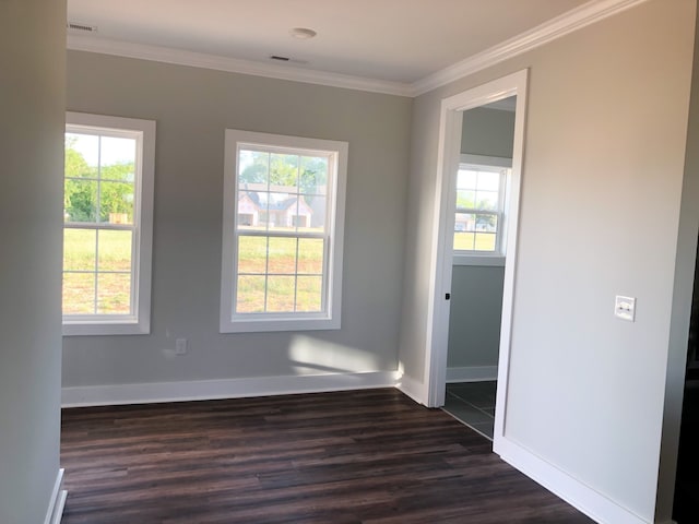 unfurnished room with ornamental molding, a healthy amount of sunlight, and dark wood-type flooring