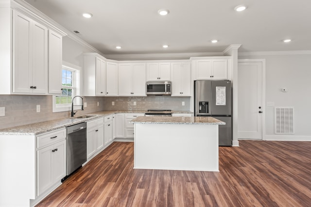 kitchen with dark hardwood / wood-style flooring, sink, stainless steel appliances, and white cabinets