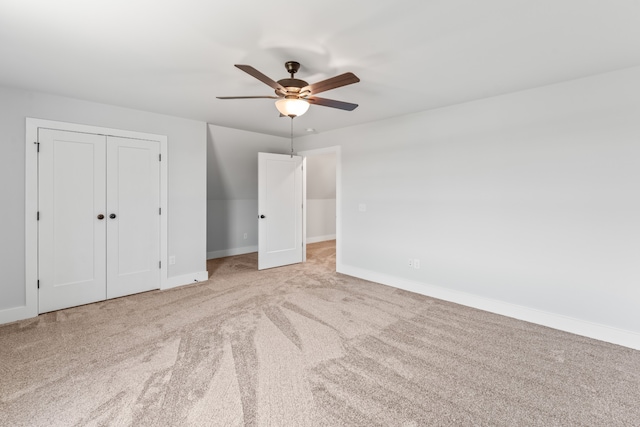 unfurnished bedroom with ceiling fan, a closet, and light colored carpet