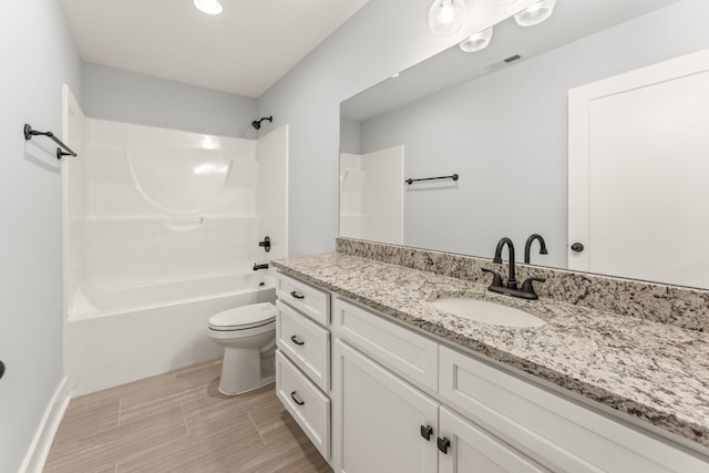 full bathroom with washtub / shower combination, vanity, and toilet