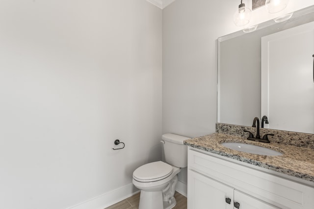 bathroom featuring wood-type flooring, vanity, and toilet