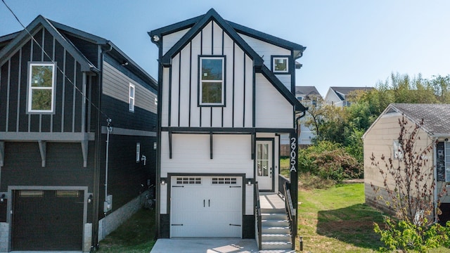 view of front of property with board and batten siding, an attached garage, and concrete driveway