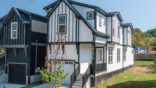 view of front of house featuring fence and a garage