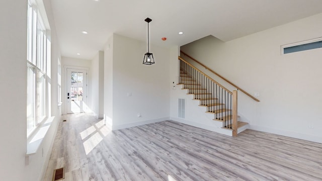 interior space featuring stairway, visible vents, baseboards, light wood-style flooring, and recessed lighting