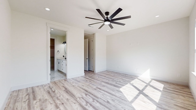 unfurnished bedroom with baseboards, recessed lighting, ceiling fan, ensuite bathroom, and light wood-type flooring