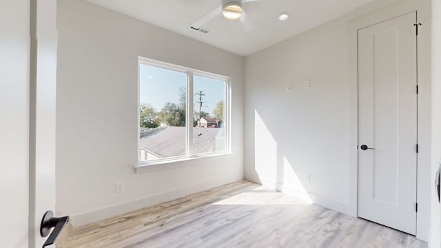 unfurnished room featuring light hardwood / wood-style flooring and ceiling fan