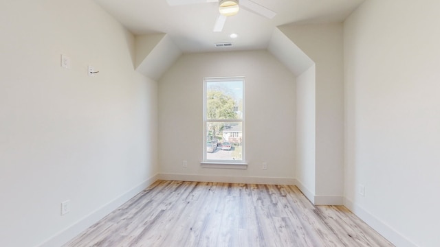 additional living space with visible vents, a ceiling fan, baseboards, and wood finished floors