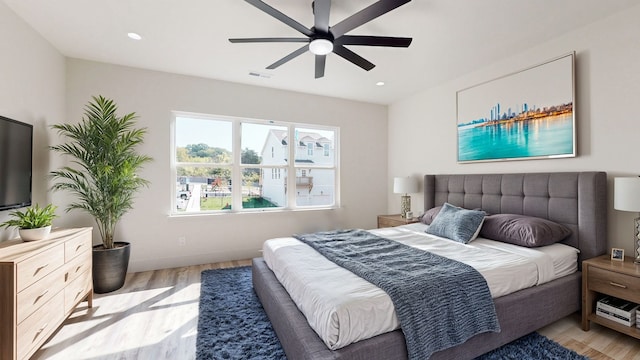 bedroom featuring light wood-type flooring and ceiling fan