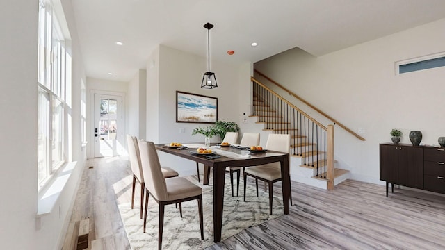 dining room featuring stairs, light wood-style flooring, and recessed lighting