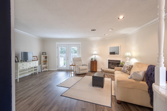 living room featuring wood-type flooring, french doors, crown molding, and a textured ceiling