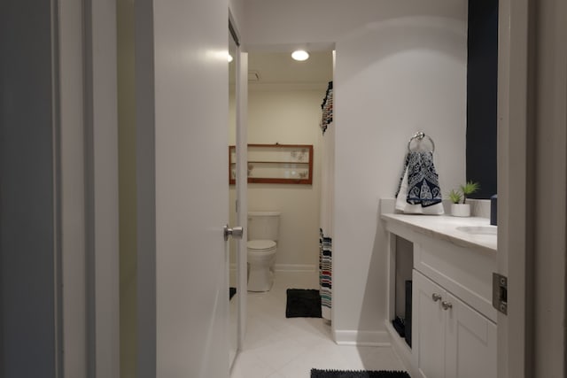 bathroom with vanity, tile patterned flooring, and toilet